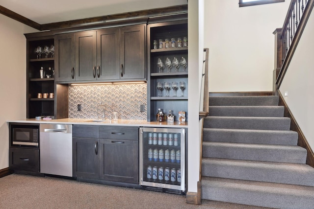 bar with light carpet, stainless steel appliances, beverage cooler, and tasteful backsplash