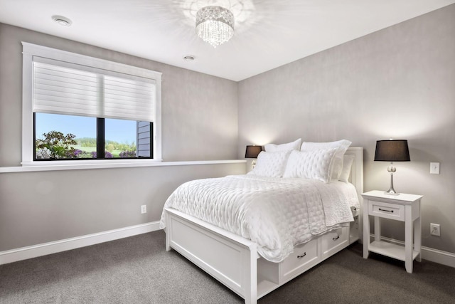 carpeted bedroom featuring an inviting chandelier