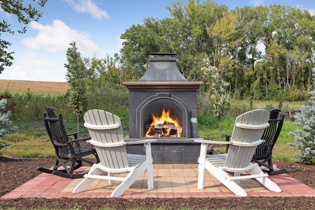 view of patio with an outdoor fireplace