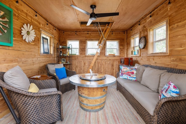 living room featuring hardwood / wood-style flooring, a wealth of natural light, and wood walls