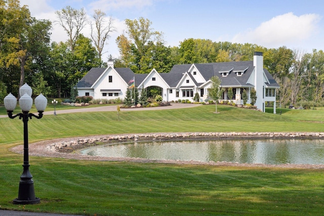 exterior space featuring a water view and a yard