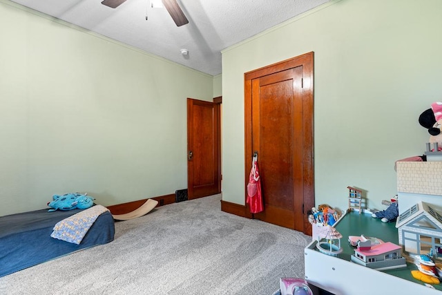 carpeted bedroom featuring ceiling fan and a textured ceiling