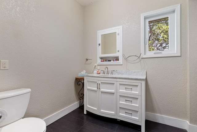 bathroom with vanity, toilet, and tile patterned floors