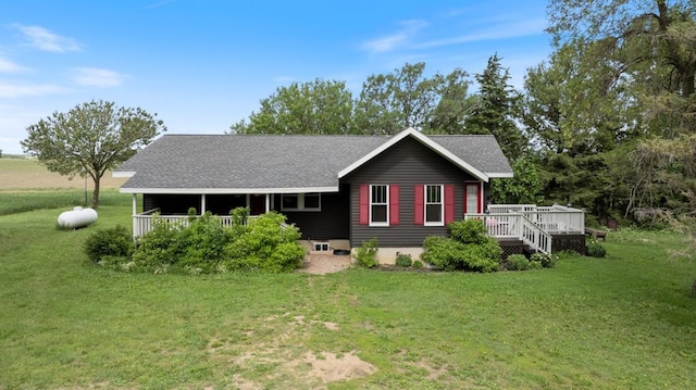 rear view of house with a deck and a yard