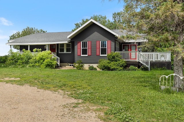 view of front of home with a front yard and a deck