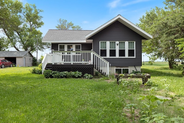 view of front facade featuring a front lawn and a deck