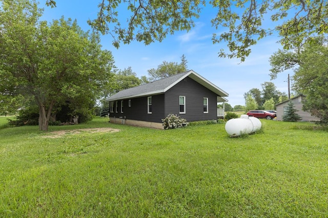 view of side of property with a yard