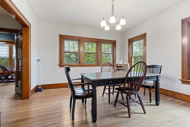 dining room with a notable chandelier and light hardwood / wood-style floors