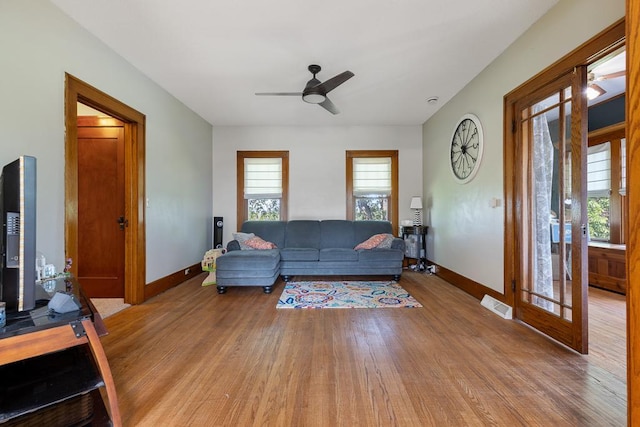 living room featuring light wood-type flooring and ceiling fan