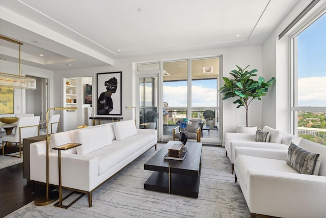 living room with hardwood / wood-style floors and a healthy amount of sunlight