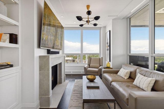 living room with a fireplace, hardwood / wood-style flooring, and a notable chandelier