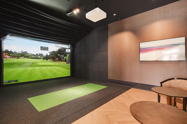 recreation room with parquet floors and golf simulator