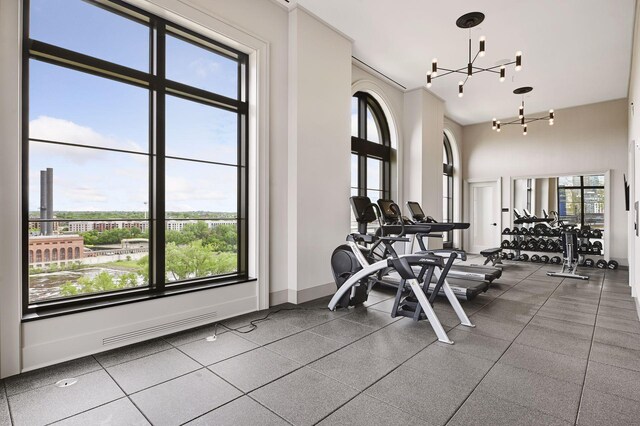 gym featuring an inviting chandelier