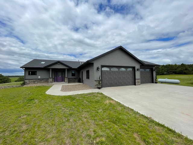 view of front of house featuring a garage and a front lawn