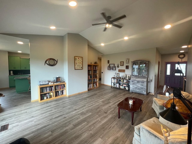 living room with wood-type flooring, ceiling fan, and lofted ceiling