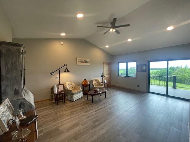 sitting room featuring ceiling fan, wood-type flooring, and vaulted ceiling