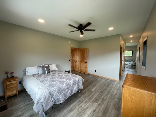 bedroom with ceiling fan and dark hardwood / wood-style flooring