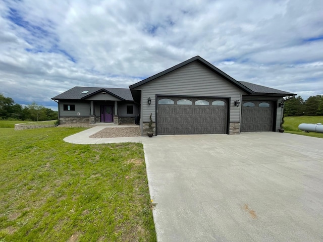 view of front of home featuring a front yard and a garage