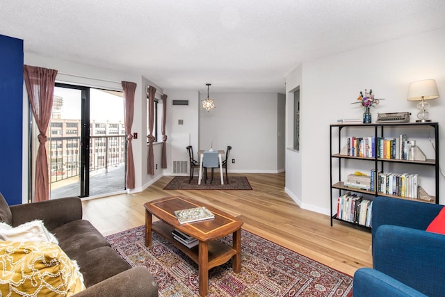 living room featuring hardwood / wood-style floors and a textured ceiling