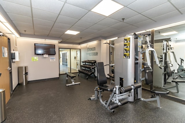 gym featuring a paneled ceiling