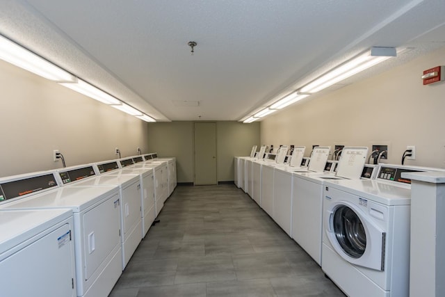 laundry room with washer and dryer and a textured ceiling