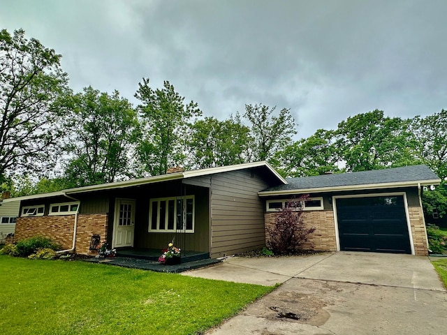 view of front of house with a garage, concrete driveway, brick siding, and a front lawn