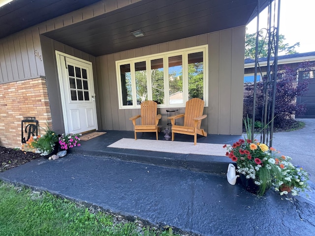 view of exterior entry with brick siding