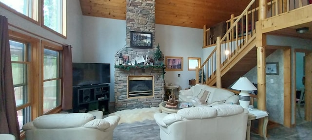 living room with high vaulted ceiling, a stone fireplace, and wooden ceiling