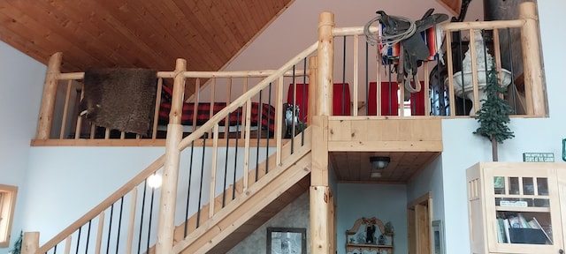 stairway with high vaulted ceiling and wooden ceiling