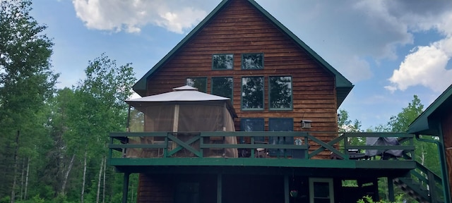 back of house with a wooden deck and a gazebo