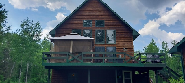 back of house with a wooden deck and a gazebo