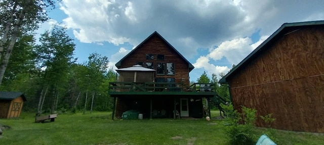 back of house with a wooden deck, a gazebo, and a yard