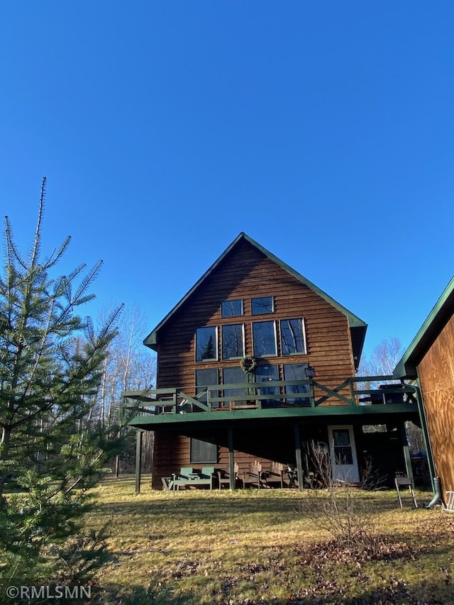 rear view of house featuring a deck