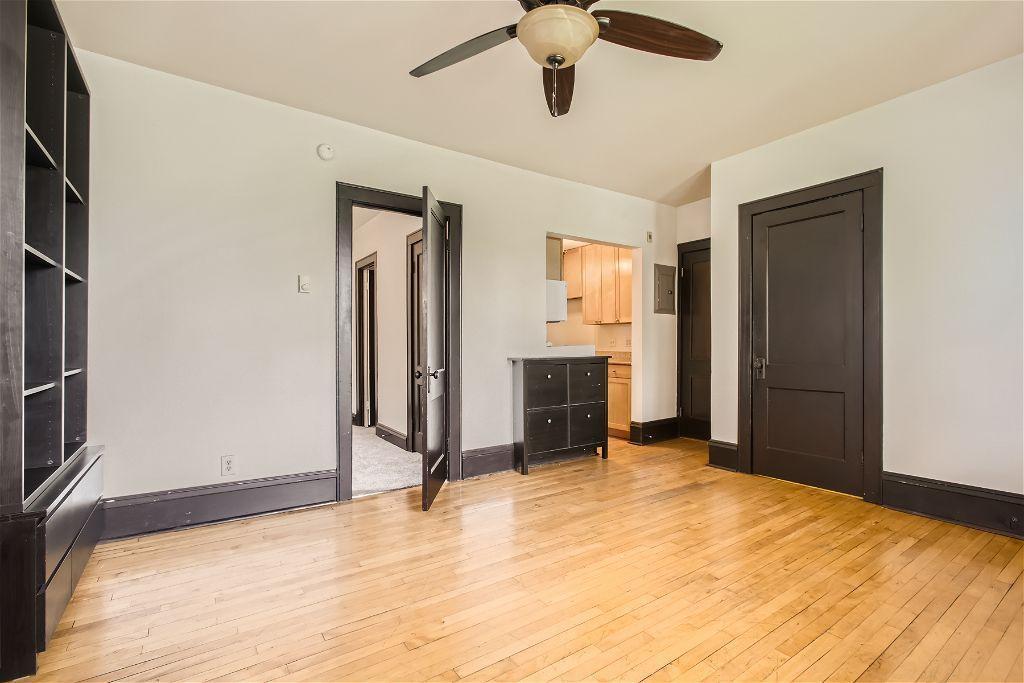 spare room with ceiling fan and light wood-type flooring