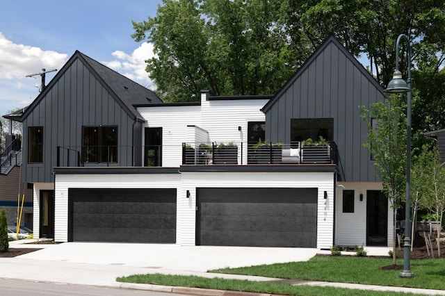 modern farmhouse with a balcony, an attached garage, board and batten siding, and driveway