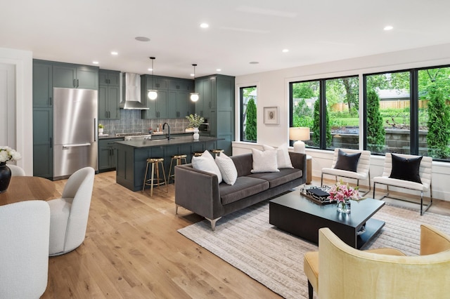 living room with sink and light hardwood / wood-style flooring