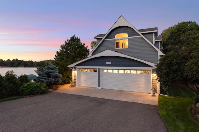 exterior space featuring driveway and a water view