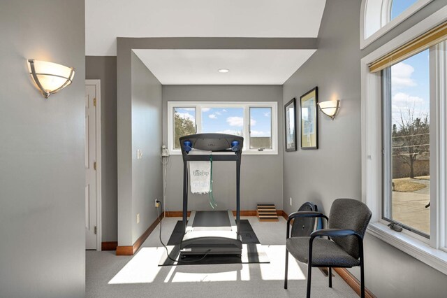 exercise room with carpet flooring and baseboards