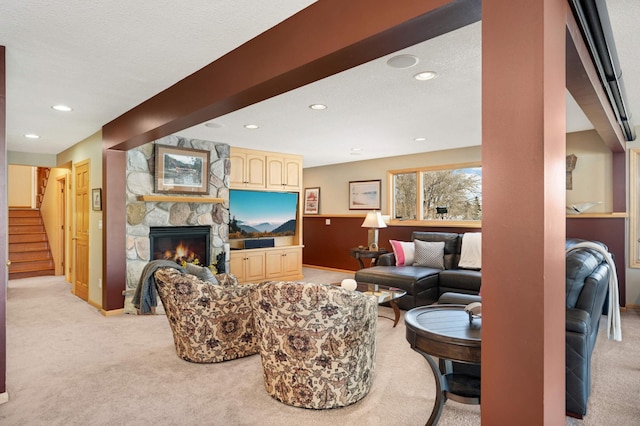 living room featuring recessed lighting, a fireplace, stairway, and light colored carpet