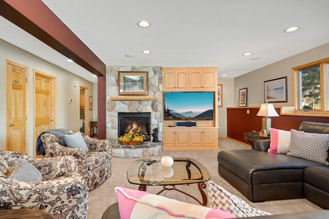 living room with recessed lighting, light colored carpet, and a stone fireplace