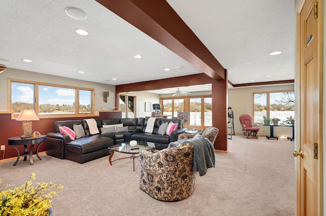 living room with beam ceiling, recessed lighting, light colored carpet, a textured ceiling, and baseboards