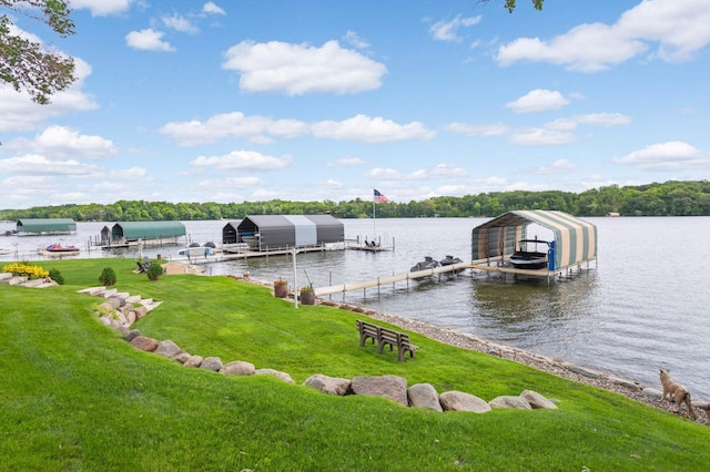 view of dock featuring a water view, a lawn, and boat lift