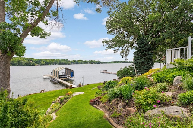 dock area featuring a yard, a water view, and boat lift