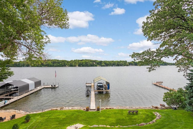 dock area with a water view and a yard