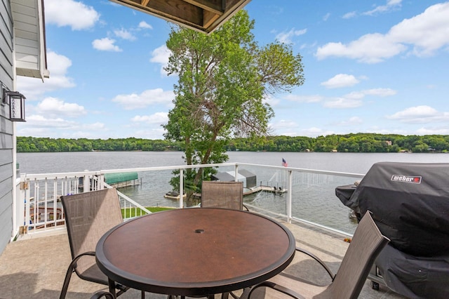 balcony featuring a water view and a grill