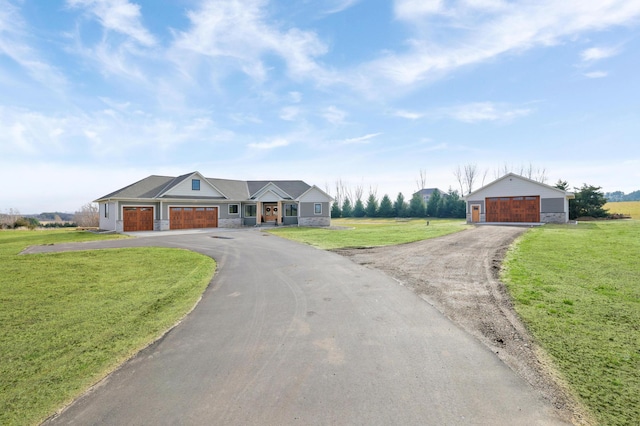 ranch-style house featuring a front yard and a garage