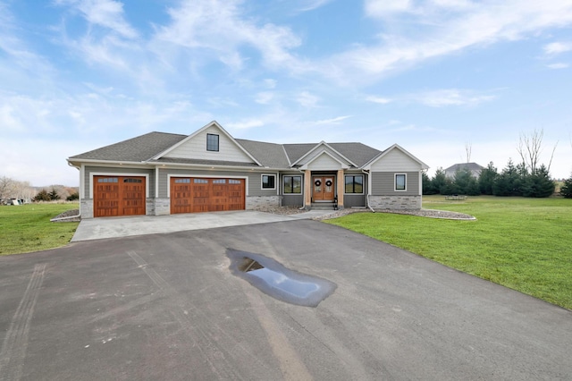 view of front of home with a garage and a front lawn