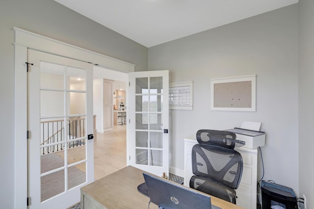 office area with french doors and light hardwood / wood-style flooring