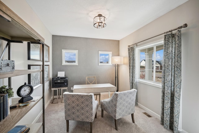 office area featuring light carpet and an inviting chandelier