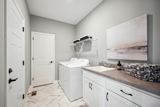 washroom featuring cabinets, separate washer and dryer, and sink